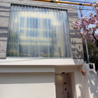 道路からは、うっすら庭が透けて見えるが、部屋のなかは見えない。３階建てのこの家は、おばあさまも使われるため、玄関の奥にはホームエレベーターをつけた