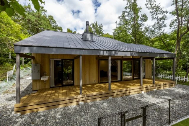 林の中に佇むA邸一見すると平屋建てのようだが実は2階建て。周囲は雑草が生えにくいよう砕石を敷いた。愛犬のための芝敷きのドッグランも設置。