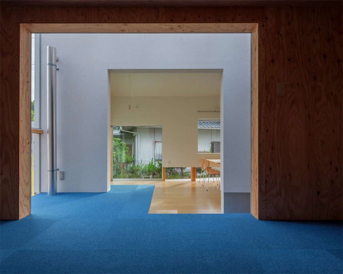 子供部屋から見た、リビング方向。里道を挟んだ隣家の緑が美しい。高さも同じなので、まるで地面が続いているように感じる。同じデザインで構成された開口部や窓の効果で、すべての景色がフレーミングされたように感じる
