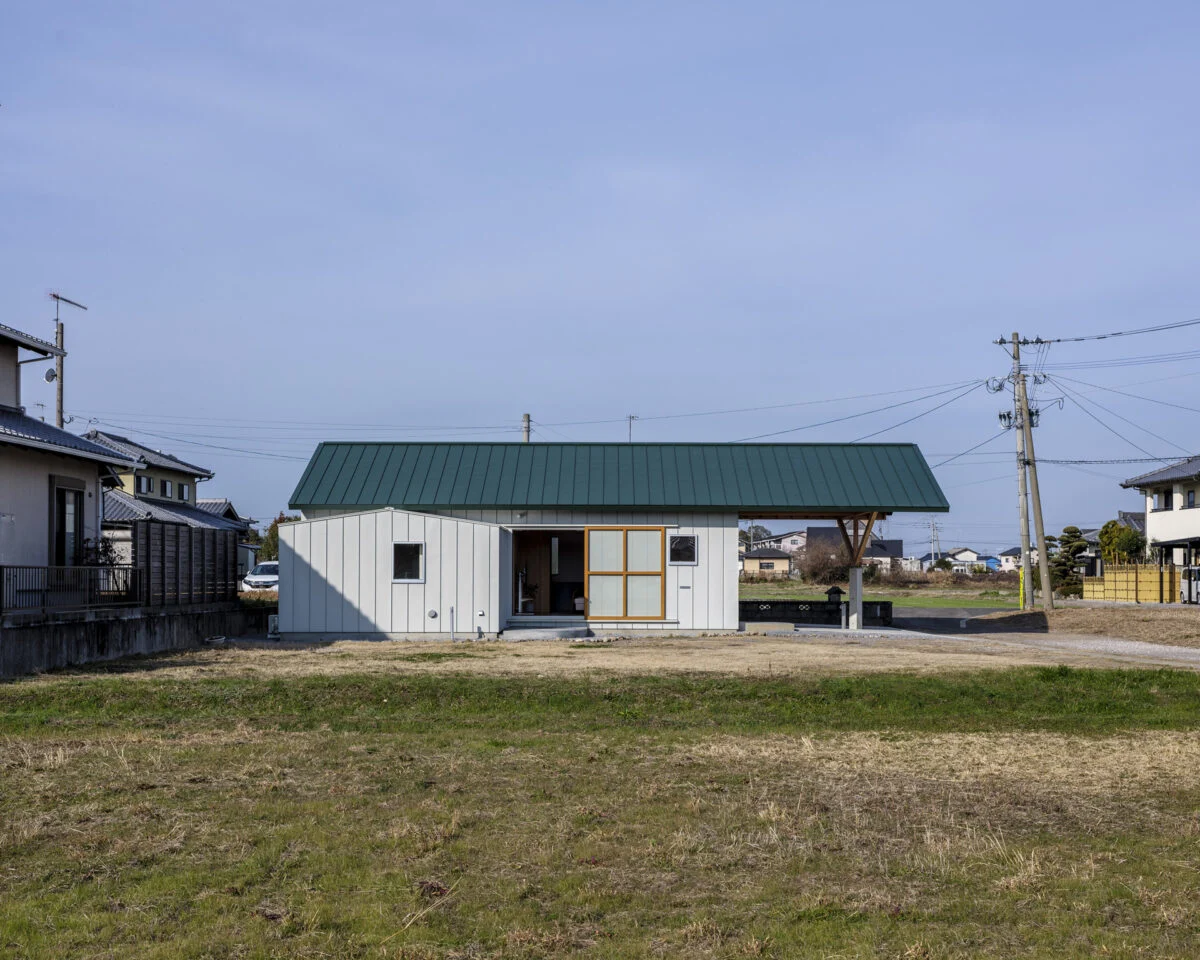 外観（東側）。とても珍しい、大屋根の張り出し。駐車場をすべて覆っていることがわかる。　構造設計の専門家の協力を得て実現した。リビングの大きな引戸は全開することができる
