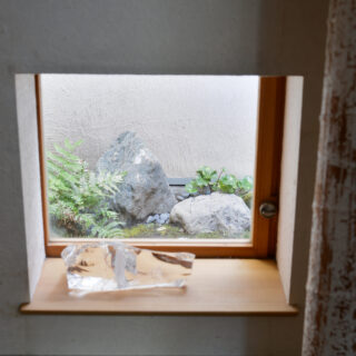 玄関横の部屋に設けられた小窓。来訪者の視線はカットしつつ、坪庭の風景を借景として楽しむことができる
