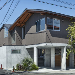 外観（南側）。2つの連続した切妻屋根、ボリュームを分割した家屋、落ち着いた壁色の採用などで、周囲に威圧感を与えず近隣に溶け込んだ存在となっている
