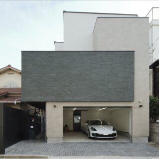 外観。2階のグレーの壁面の内側にはテラスがある。住宅街にあるため明るさを確保しつつ視線を遮った。効率的な動線も魅力。エントランスからだけでなく、ガレージからもご主人の個室やシューズクローク、室内へダイレクトにアクセスできる
