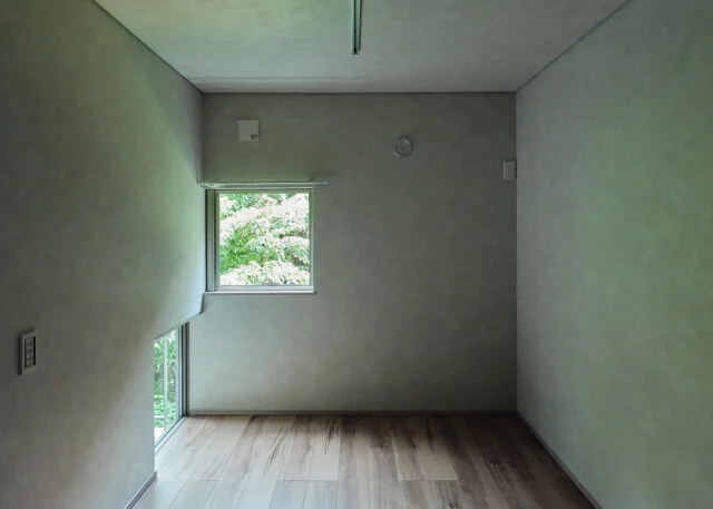 森に面した森棟、庭棟の個室には緑を眺められる窓が複数ある。写真左下はインナーバルコニーに面した地窓。立っているとき、座っているときで森の見え方が変わり、室内で過ごす時間がいっそう楽しくなる
