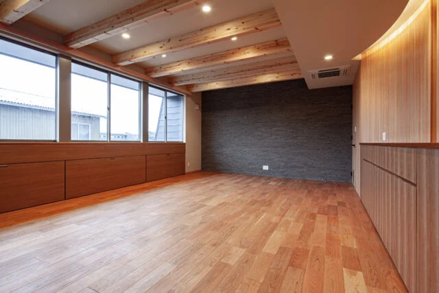 ２階の廊下は、一部にR曲線をつけ、視覚的な奥行きとわくわく感を演出。リビングの扉には、愛猫が自由に、かつ安全に行き来できるよう専用のペットドアも設置。家族の一員である猫との快適な共生への配慮。