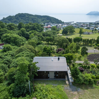 敷地の前には公園があり、その先に街並み、内浦湾と続く。グラデーションのように連なる景色が美しい